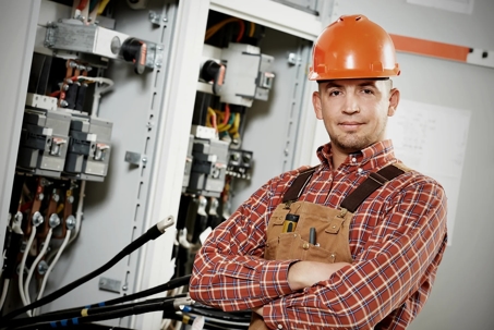 Electrician beside an Electric Panel