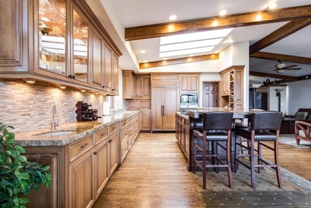 A well-lit kitchen showcases woodworking and design for a luxury home.