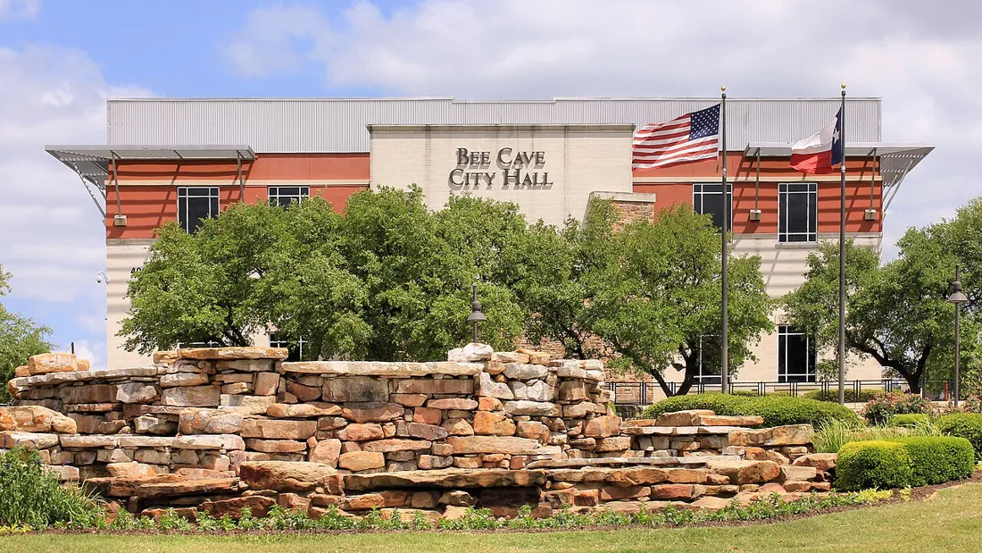 Bee Cave City Hall behind a limestone fountain and landscaped grounds