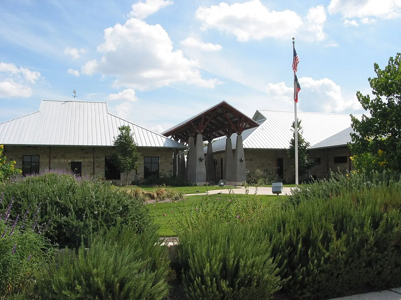 Leander Public Library with a landscaped garden and Texas-style metal roof