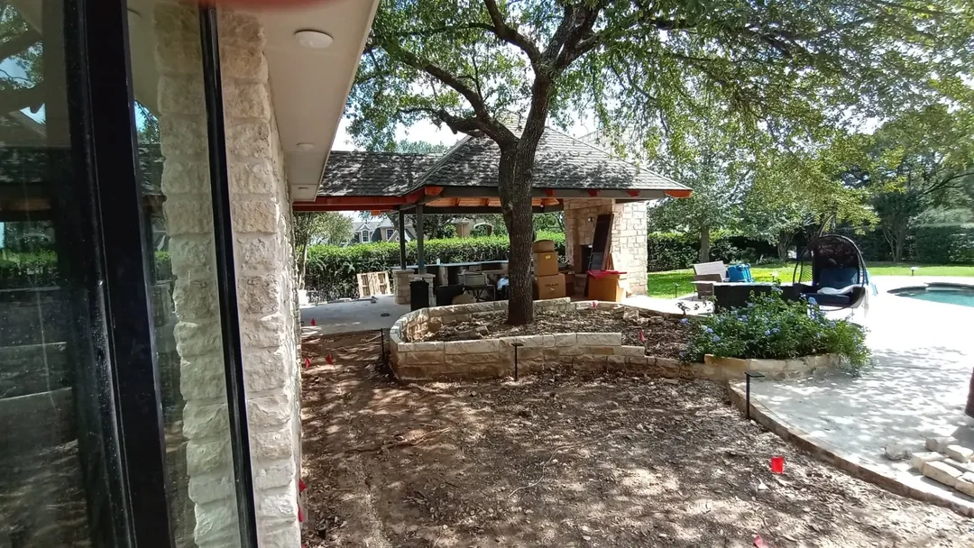 Backyard with a shaded patio, pavilion, and swimming pool.
