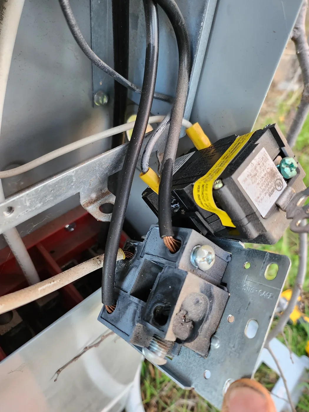 Close-up of electrical receptacle wiring inside an open enclosure.