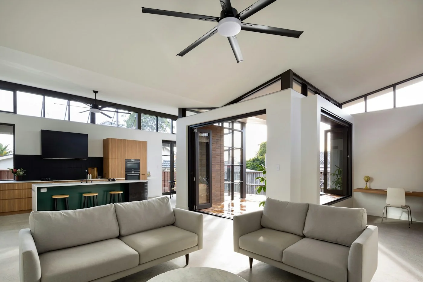Ceiling fan above a bright living room with exposed beams